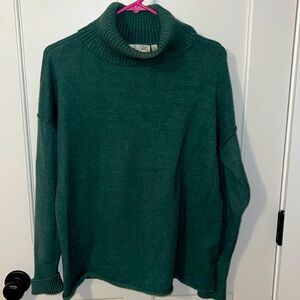 Soft green turtle neck has cuffed sleeves and ribbing at shoulders
